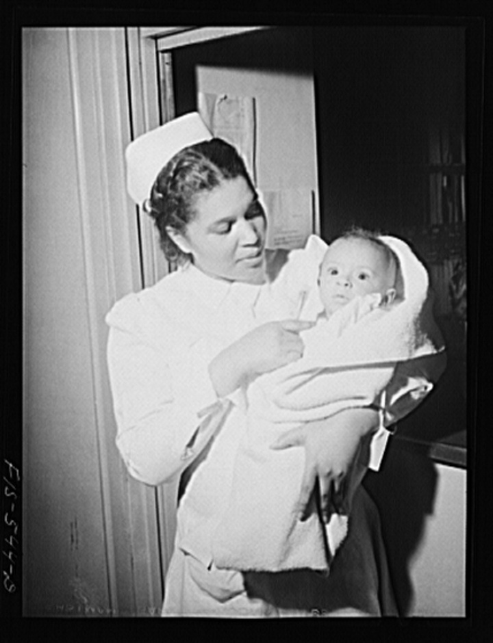 Chicago, Illinois. Provident Hospital. Miss Irene Hill, nurse technician, taking baby to be x-rayed. Jack Delano